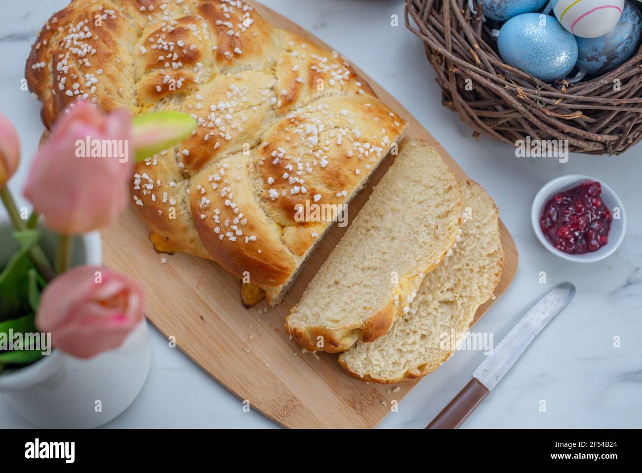 Sweet home made braided yeast bun for easter on a table Stock Photo