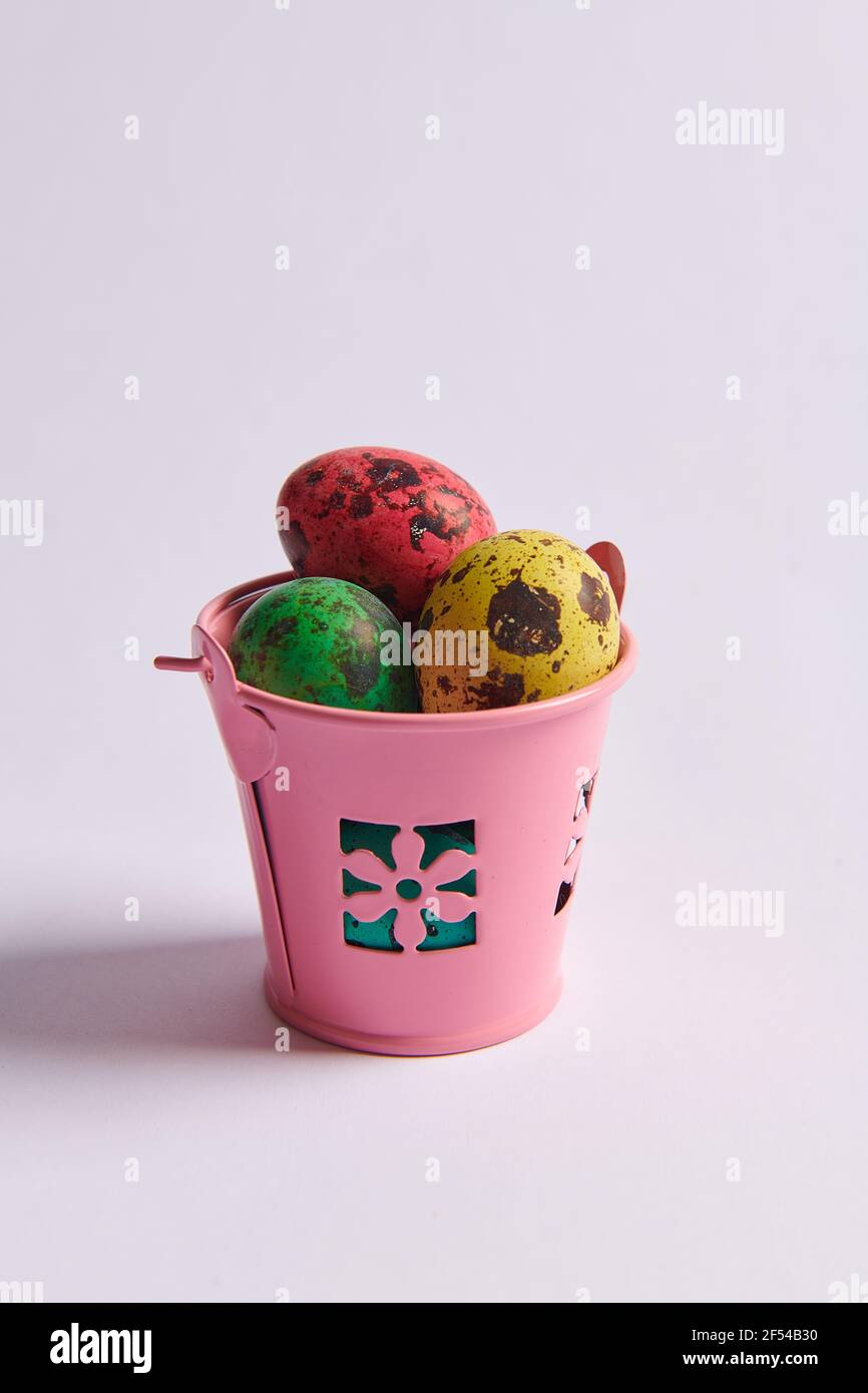 colored eggs for Easter in a bucket Stock Photo