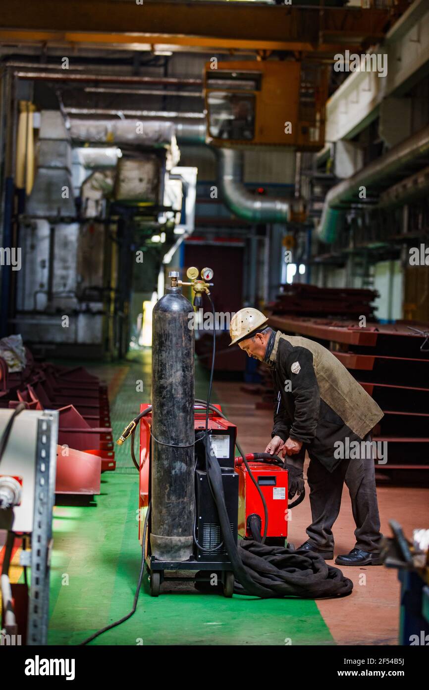 Ekibastuz, Pavlodar region, Kazakhstan, May 28 2012: Train car-building plant. Welder worker with oxyacetylene welding set. Stock Photo