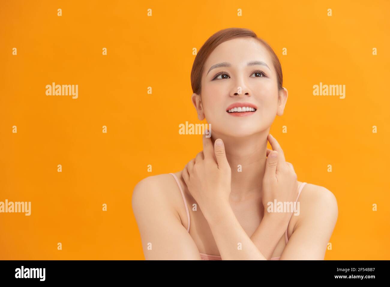 Charming woman touching her perfect soft face skin with fingers ...