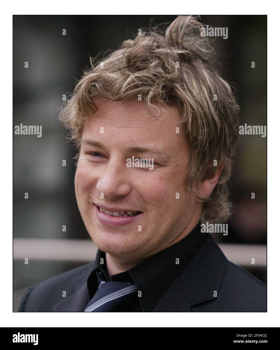 Jamie Oliver at a photocall before his press conf re school dinners held at Channel Four in Londonpic David Sandison 30/3/2005 Stock Photo
