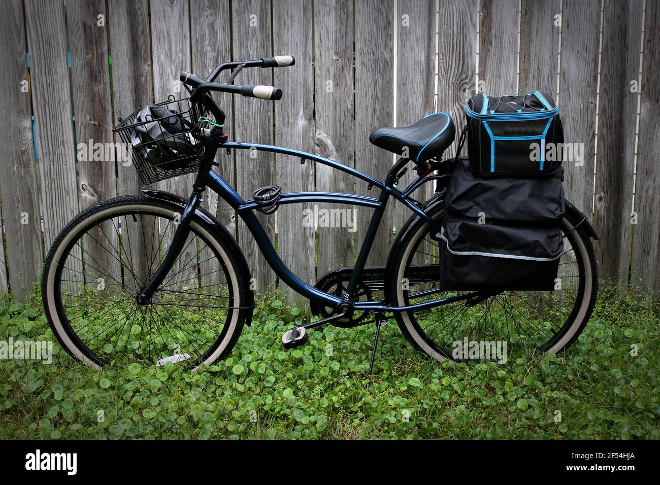 my retro cruiser no gear back pedal breaking bicycle with color coordinated lunch cooler and pannier bags Stock Photo