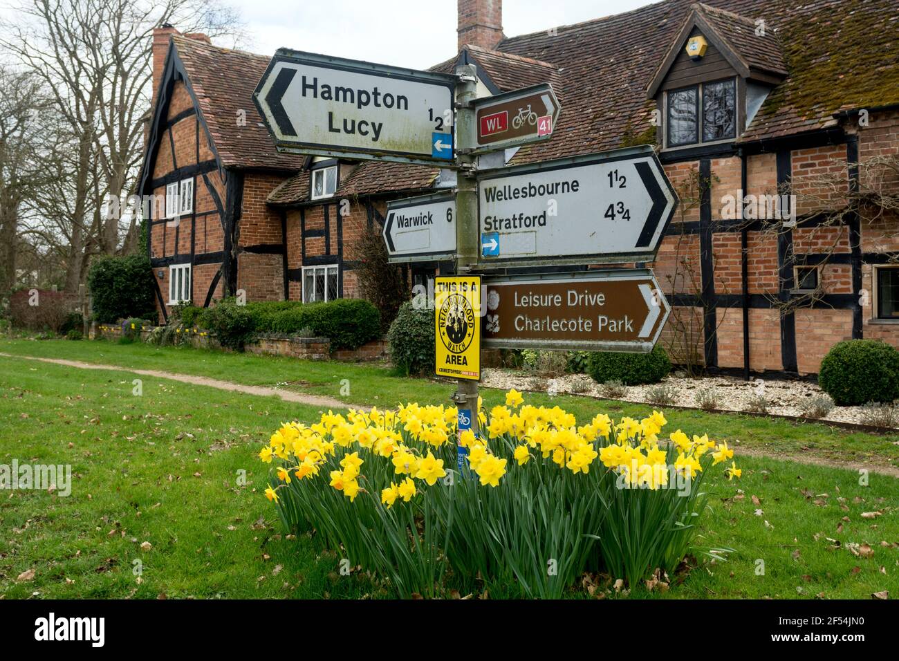 Road signs and the Malt House in spring, Charlecote, Warwickshire, England, UK Stock Photo