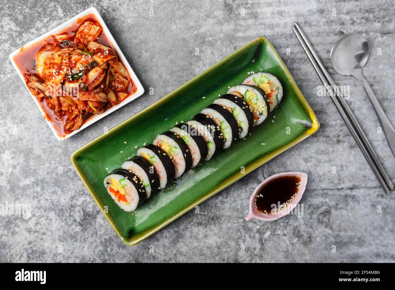 Korean food, Gimbap or Kimbap is seaweed rice roll and kimchi side dish. Stock Photo