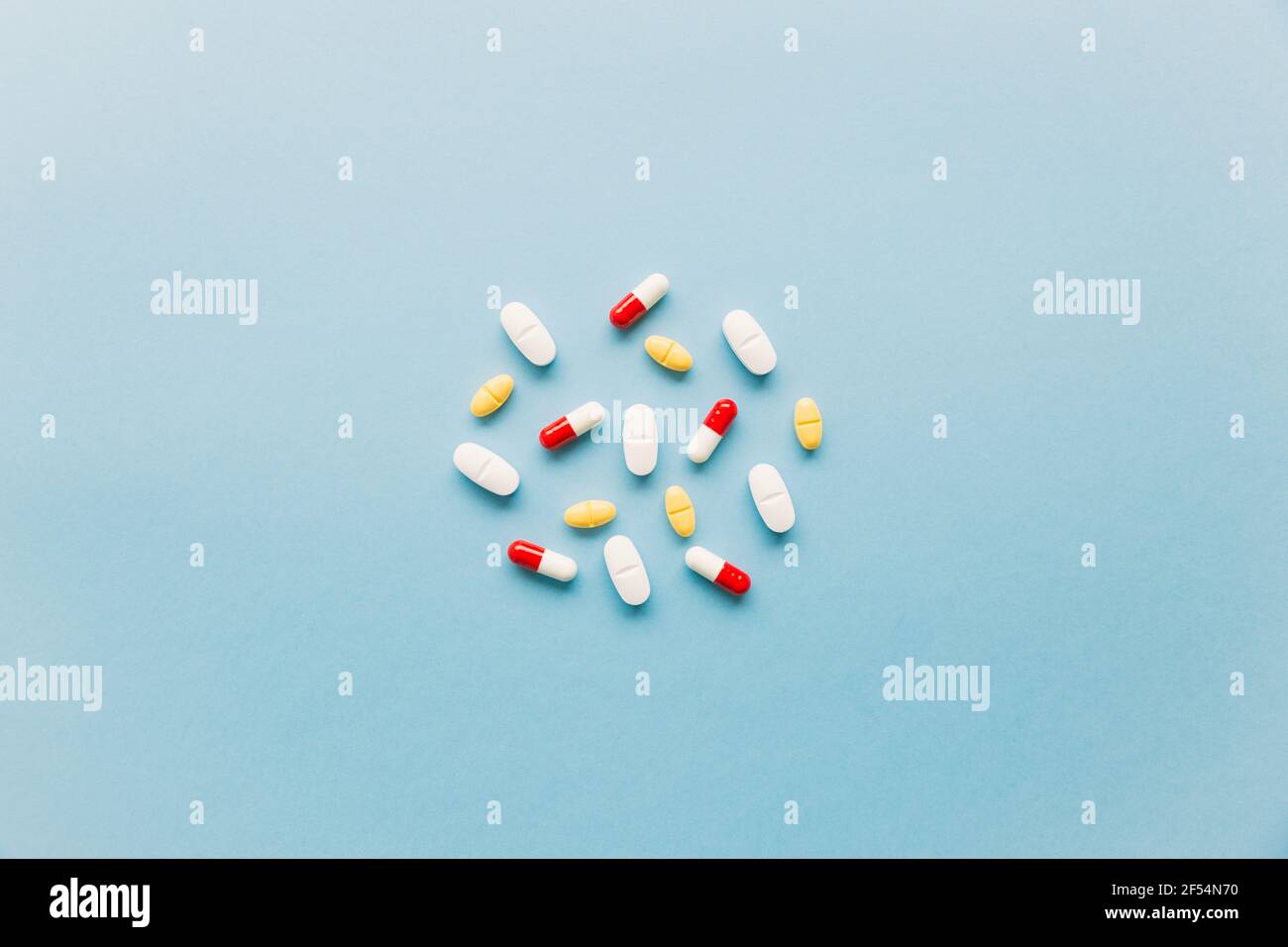 group of different medicinal pills on a blue background Stock Photo