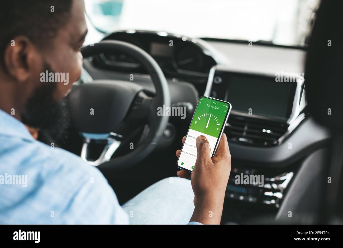 Young black guy using online smartphone app to pay for fuel inside of his car, collage Stock Photo