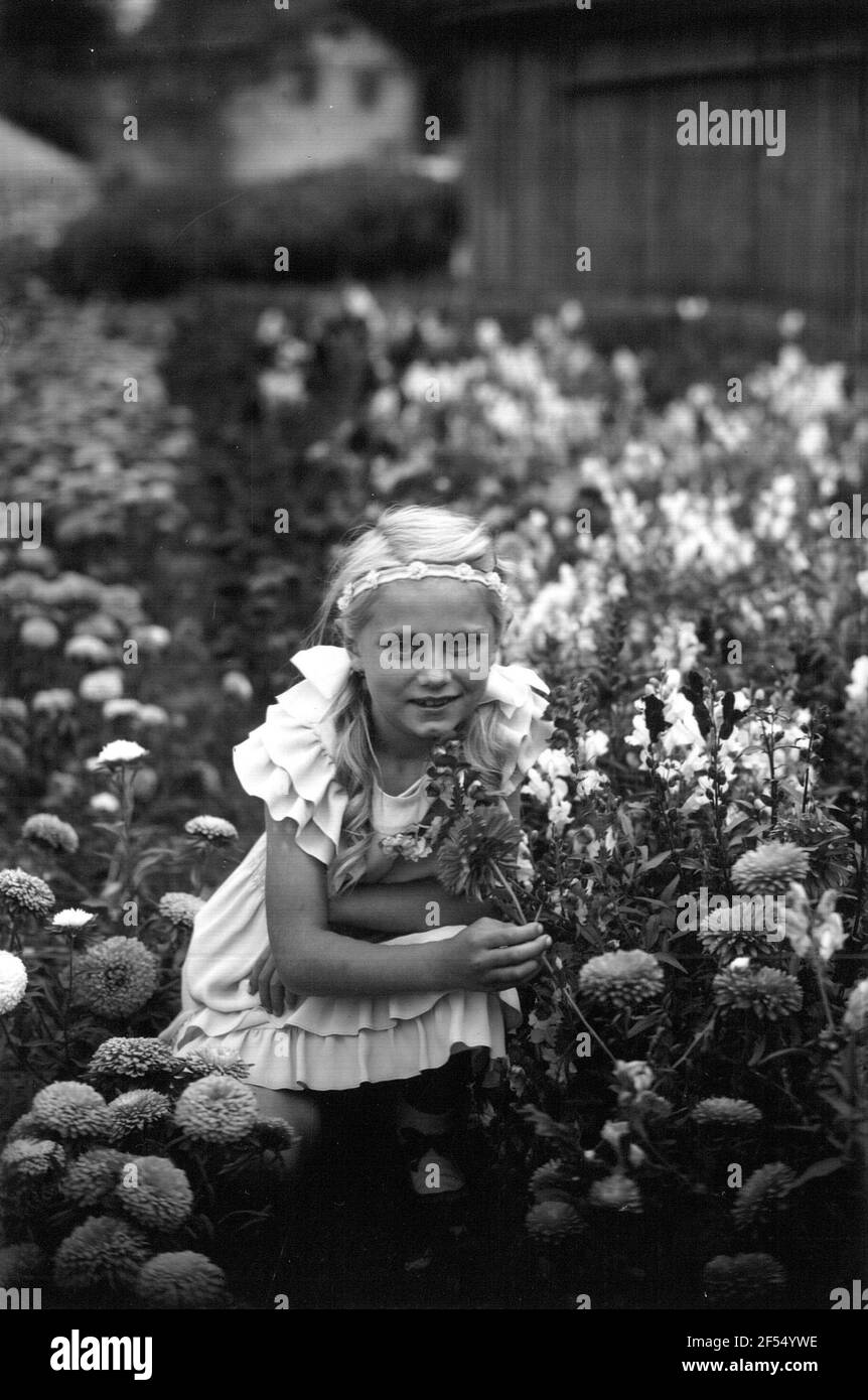 Girl from the family Lempe in a flower garden. Recording (Döbel-) Choren 1937 Stock Photo