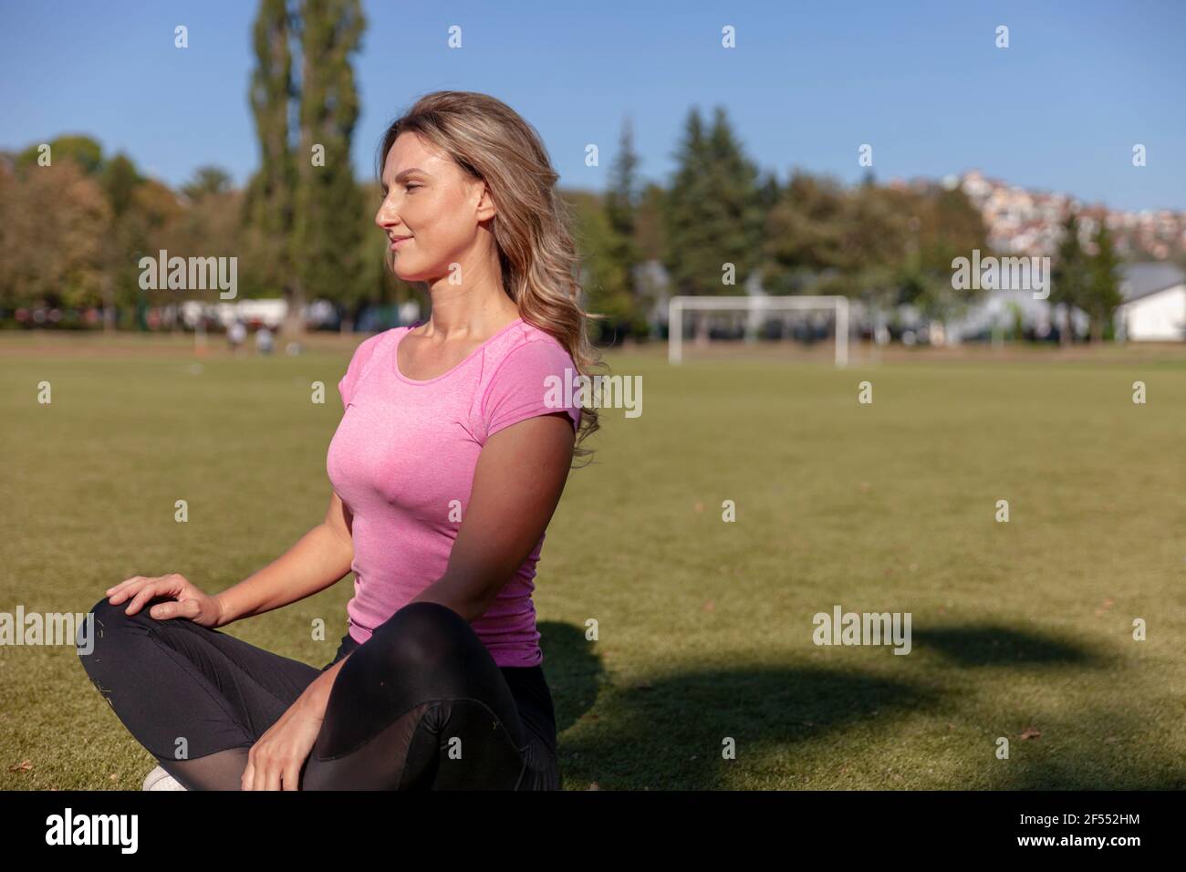 A beautiful 35-year-old woman photographed up close in sports equipment Stock Photo