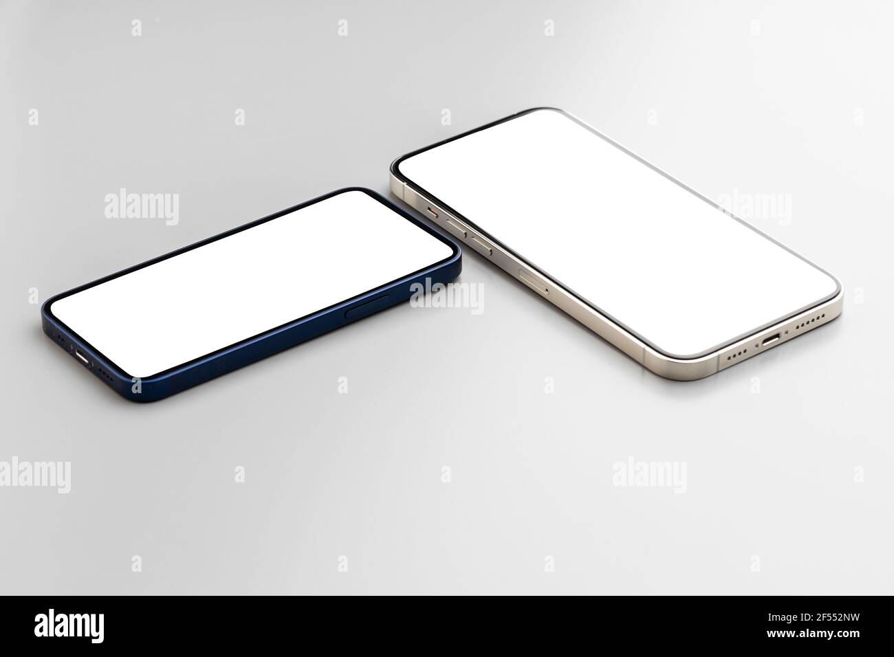 Two smartphones with blank white screen on gray background Stock Photo ...