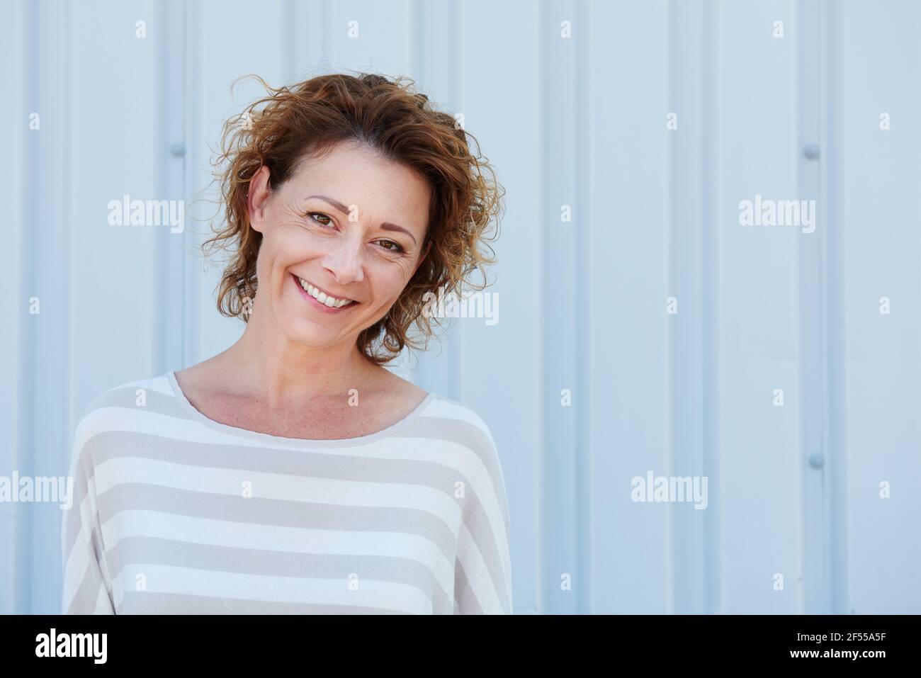 Smiling older woman standing hi-res stock photography and images - Alamy