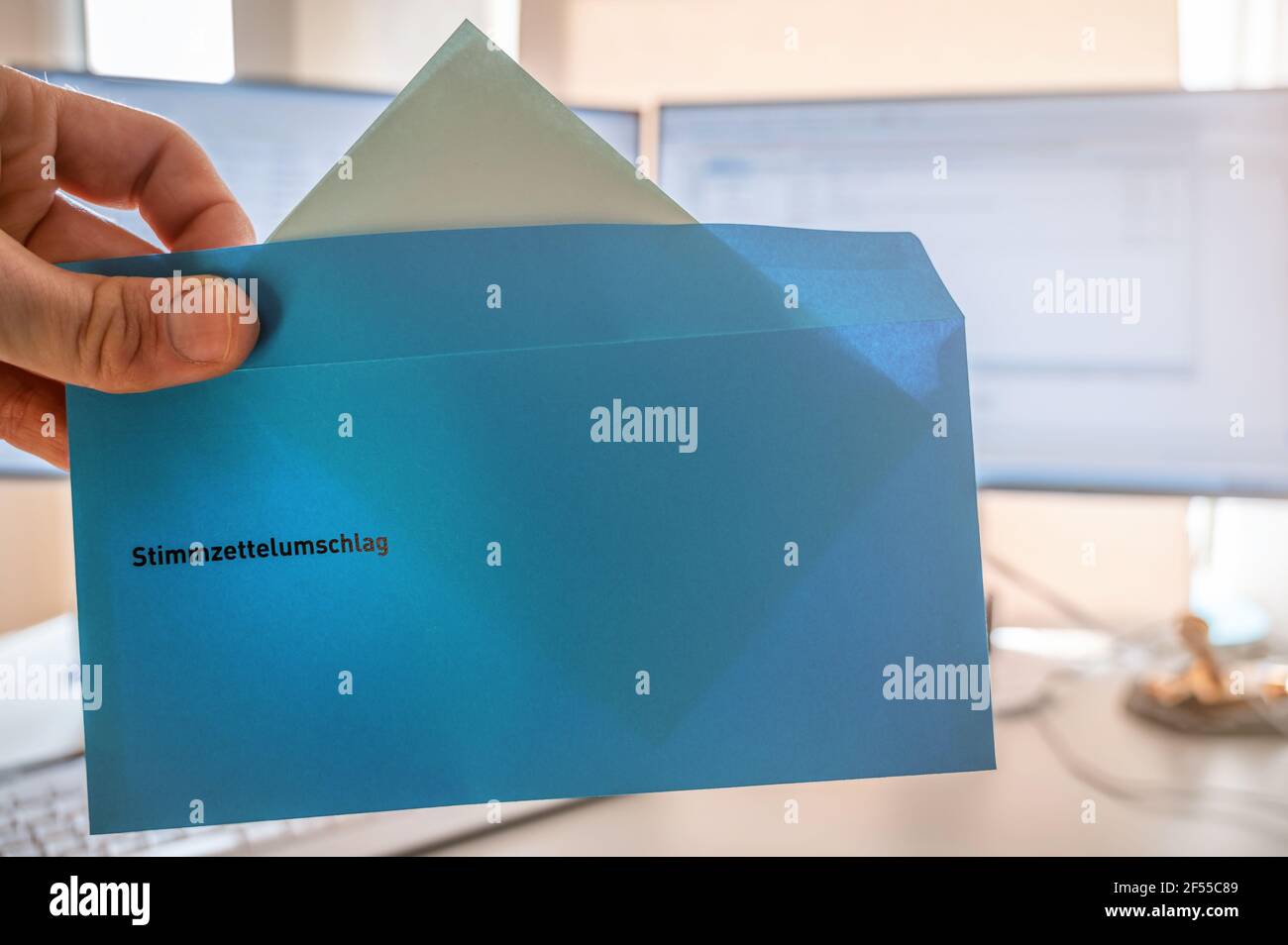 Casting one vote in the election for the new staff council with an envelope as postal vote with the word voting envelope in german language Stock Photo
