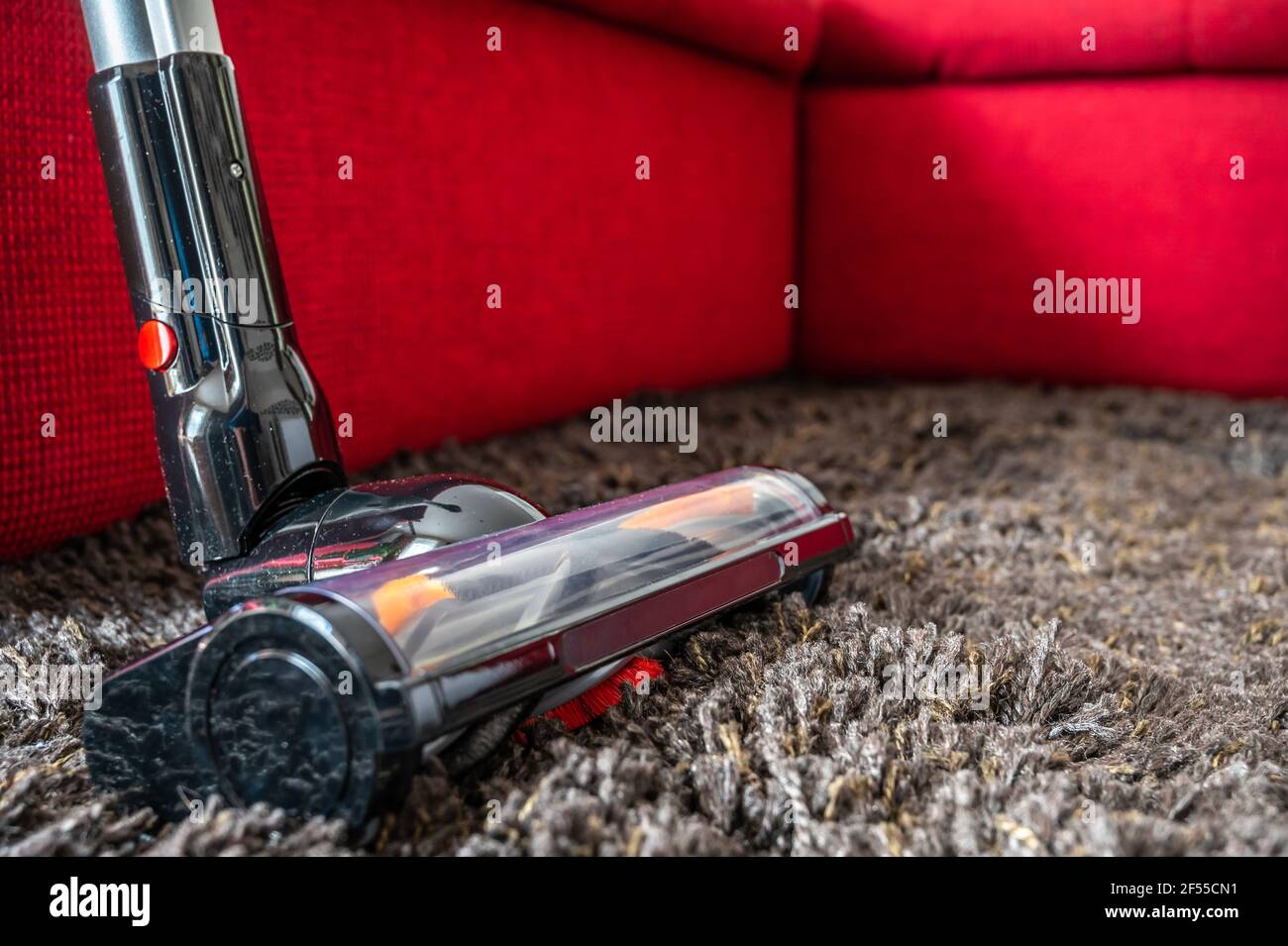 Battery operated vacuum cleaner on a long pile carpet Stock Photo Alamy