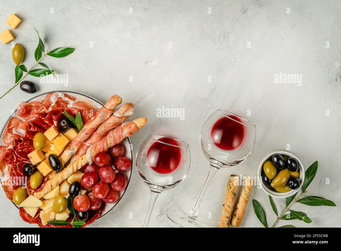 Appetizer snacks set with wine on gray background. overhead, copy space. Stock Photo
