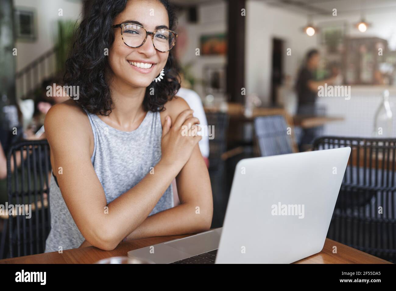 Close-up shot motivated joyful attractive female freelancer working ...
