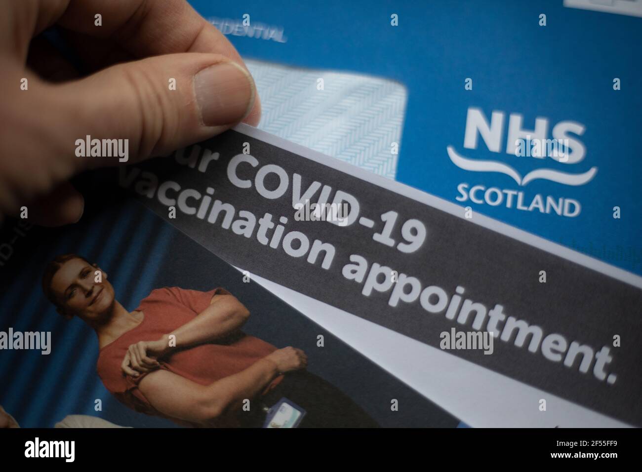 Glasgow, UK, on 24 March 2021. An NHS Scotland Covid-19 vaccination appointment letter is read by the receiver. Over 2 million people in Scotland have now had their first dose of the Covid-19 CoronaVirus vaccination. Photo credit: Jeremy Sutton-Hibbert/ Alamy Live News. Stock Photo