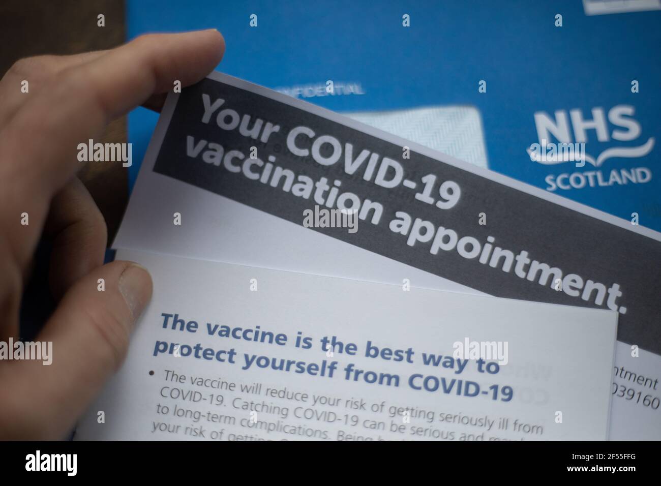 Glasgow, UK, on 24 March 2021. An NHS Scotland Covid-19 vaccination appointment letter is read by the receiver. Over 2 million people in Scotland have now had their first dose of the Covid-19 CoronaVirus vaccination. Photo credit: Jeremy Sutton-Hibbert/ Alamy Live News. Stock Photo