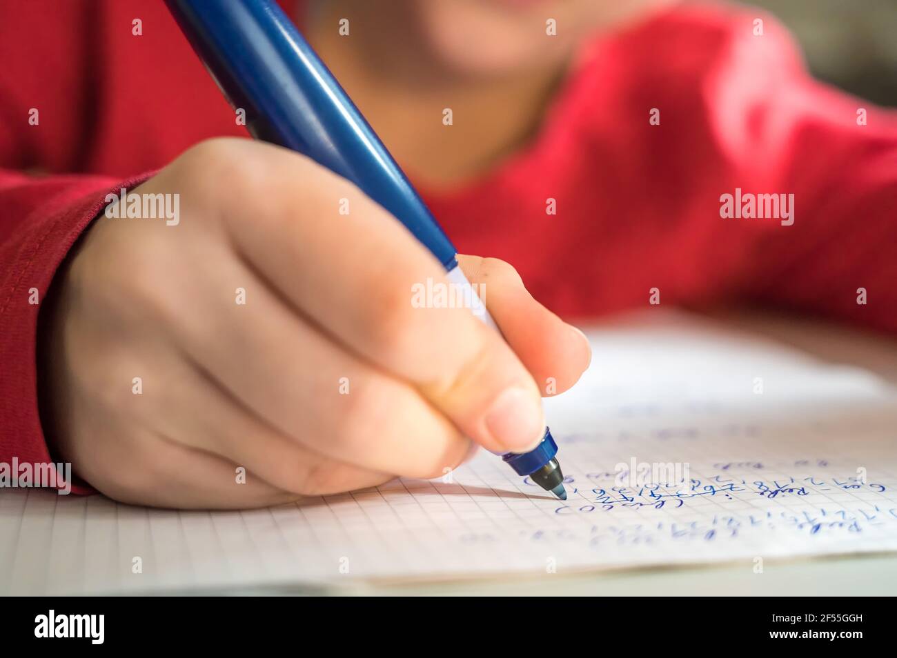 Elementary school age child practices arithmetic while solving math problems Stock Photo