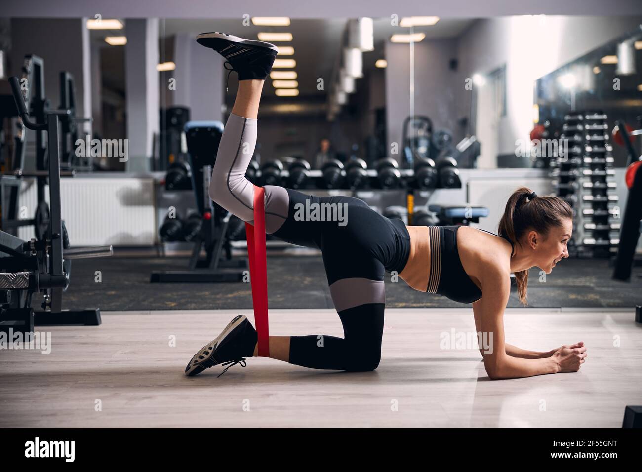 Active female person raising her leg with expander Stock Photo - Alamy