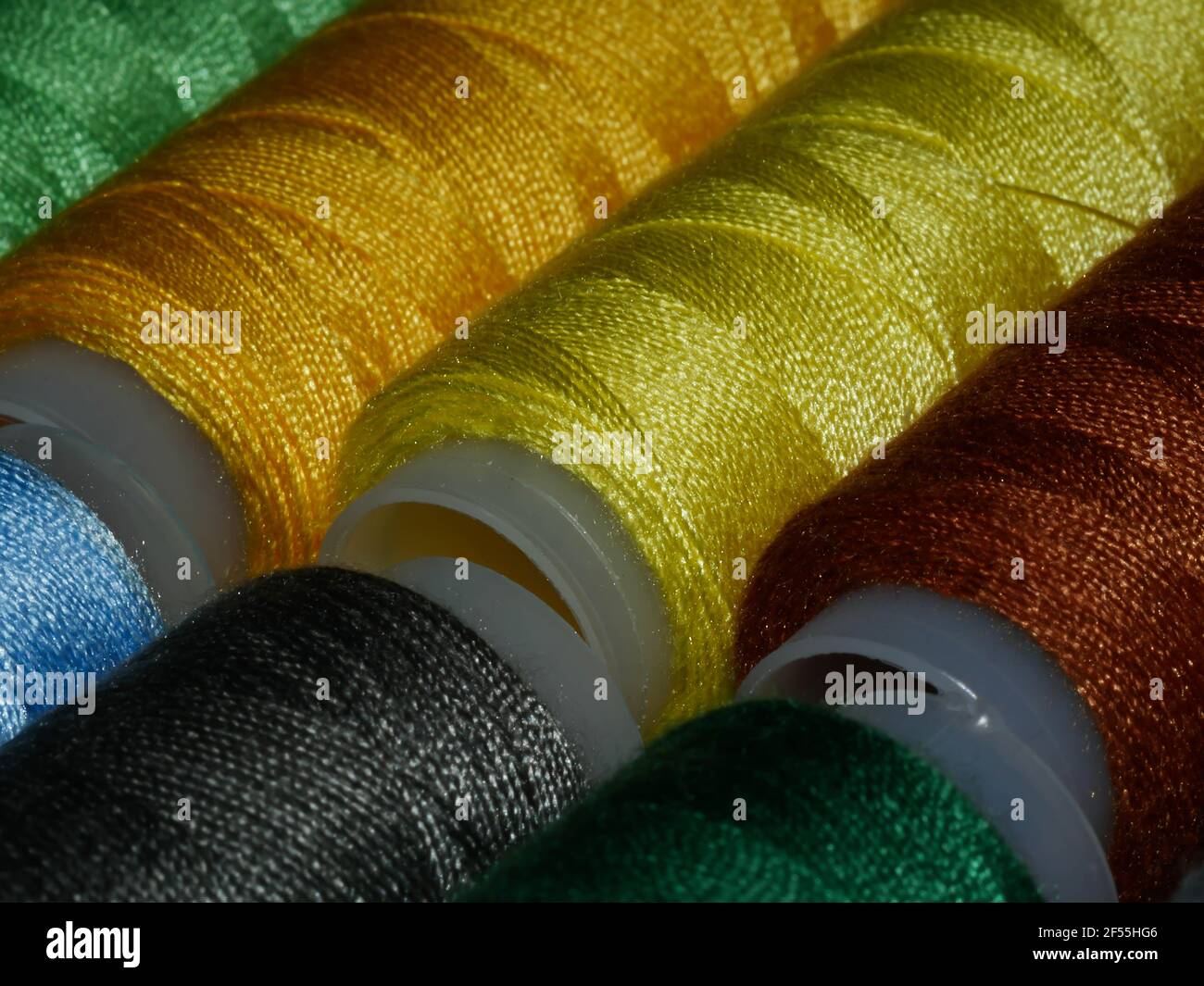 Sewing threads multicolored background closeup Stock Photo