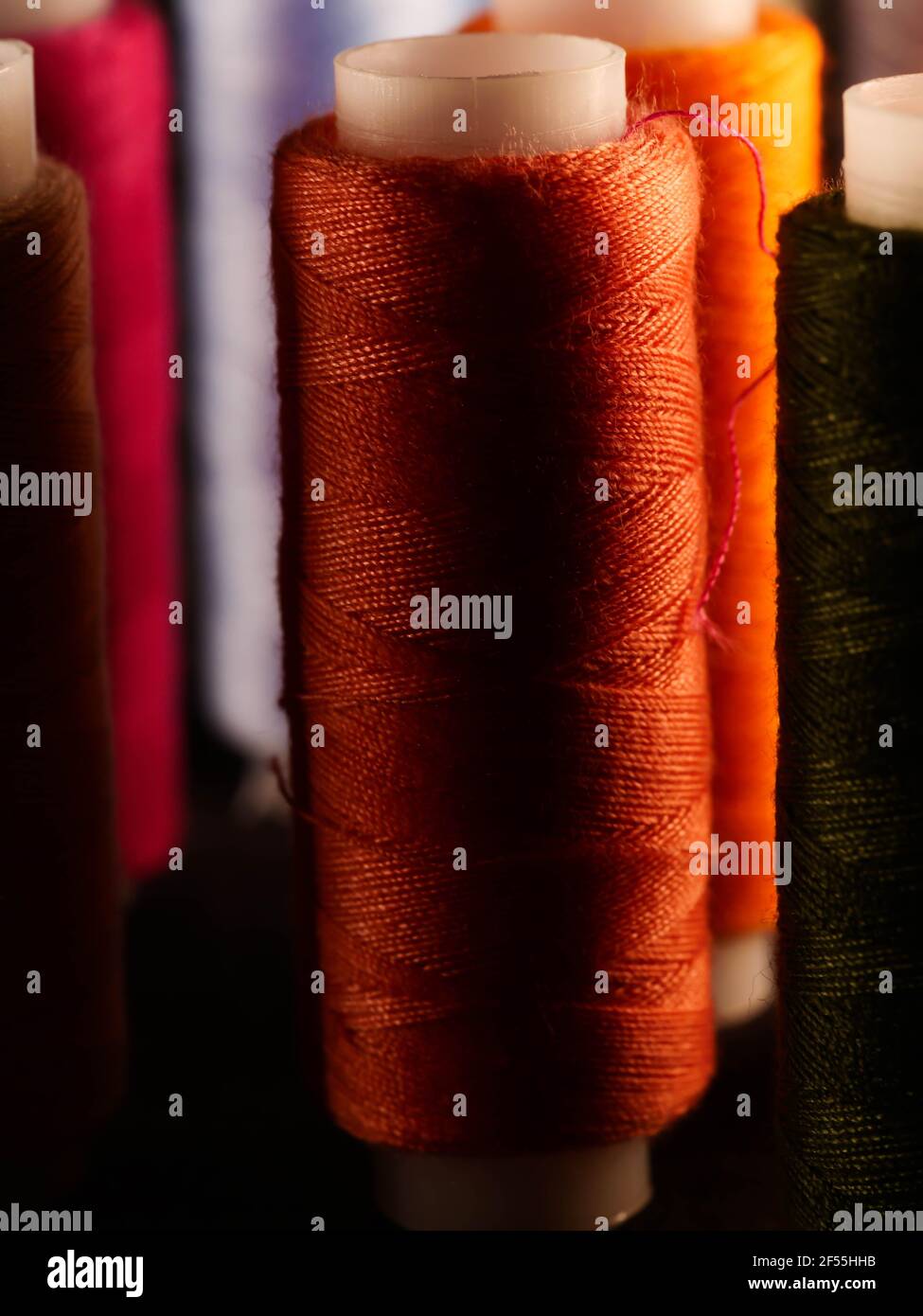 Sewing threads multicolored background closeup Stock Photo