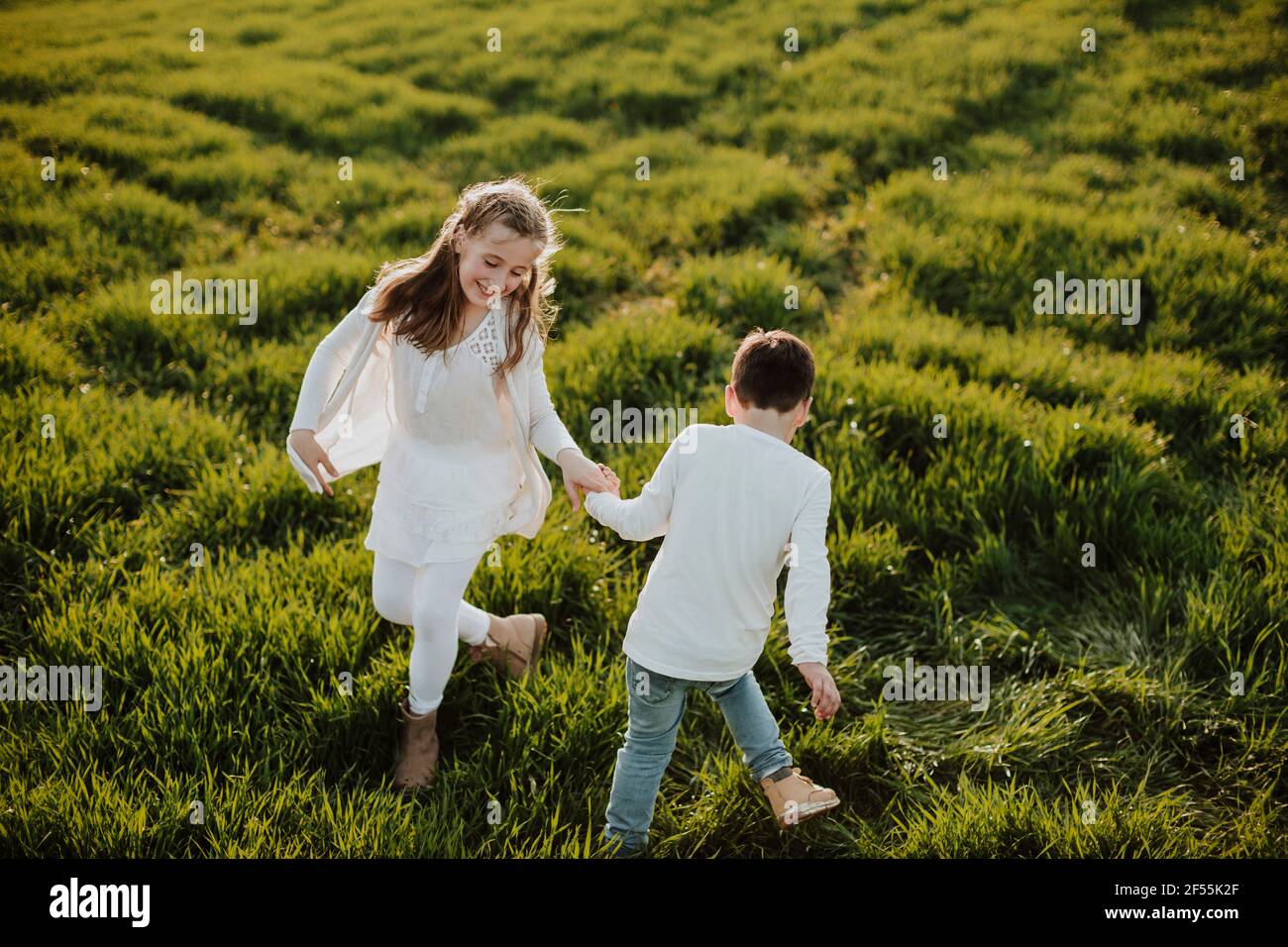 Boy and girl holding hands hi-res stock photography and images - Alamy
