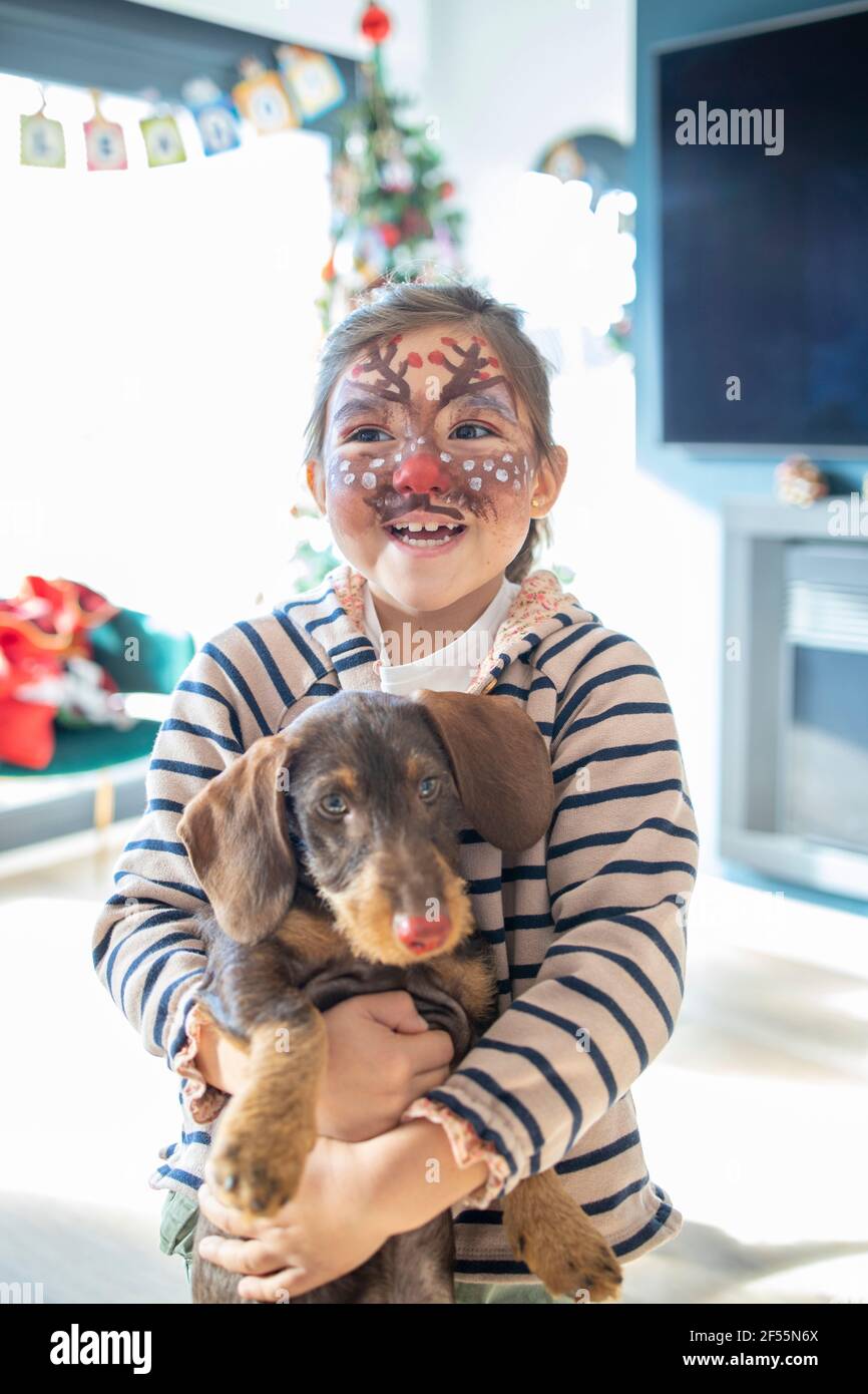 Boy with mask painted on face at home during Christmas Stock Photo