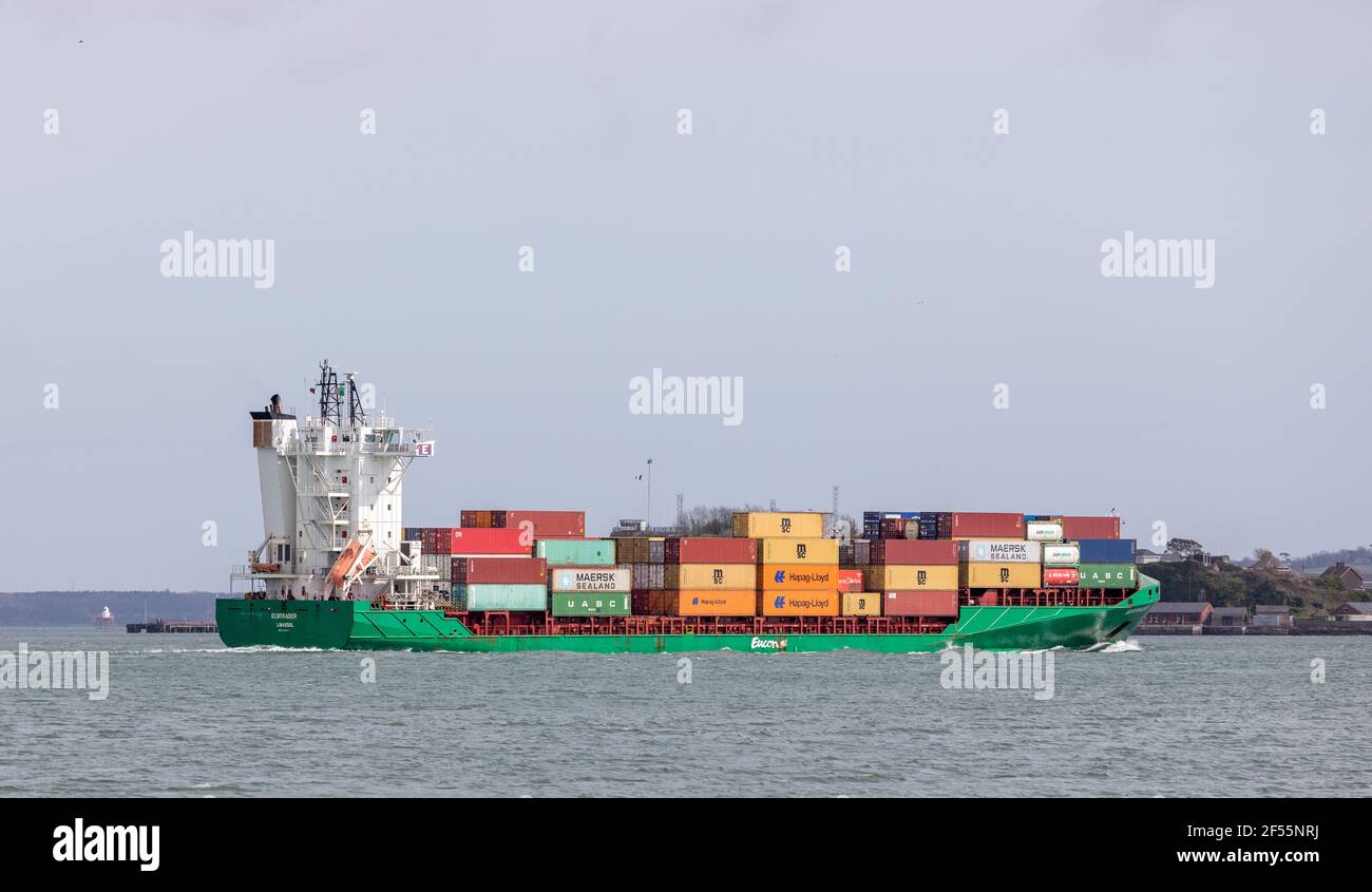 Ringaskiddy, Cork, Ireland. 24th March, 2021. Container ship Elbtrader departs Cork harbour bound for Antwerp with a cargo that was loaded at Tivoli Docks, Cork, Ireland. - Credit; David Creedon / Alamy Live News Stock Photo