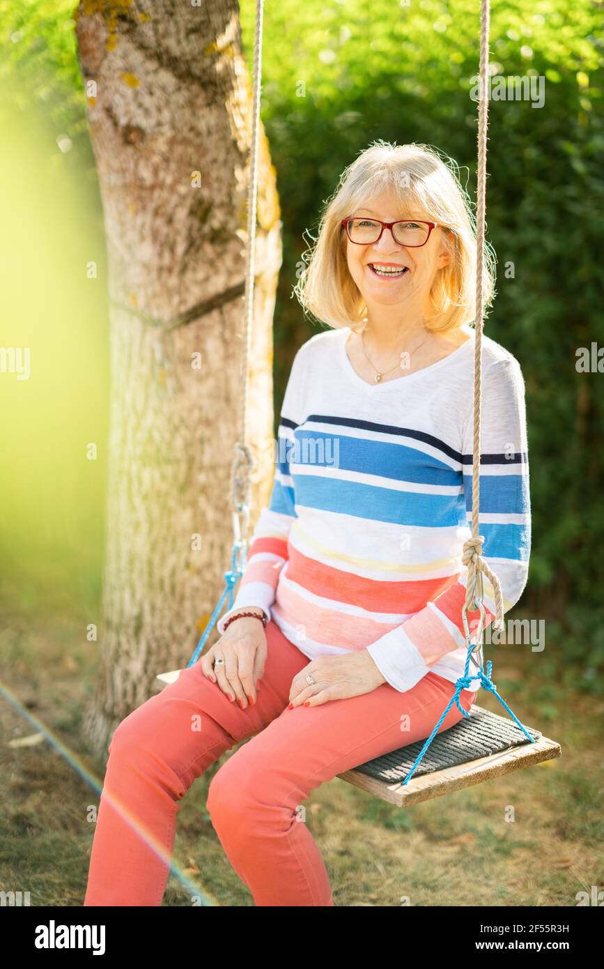 Senior woman on swing portrait hi-res stock photography and images - Alamy