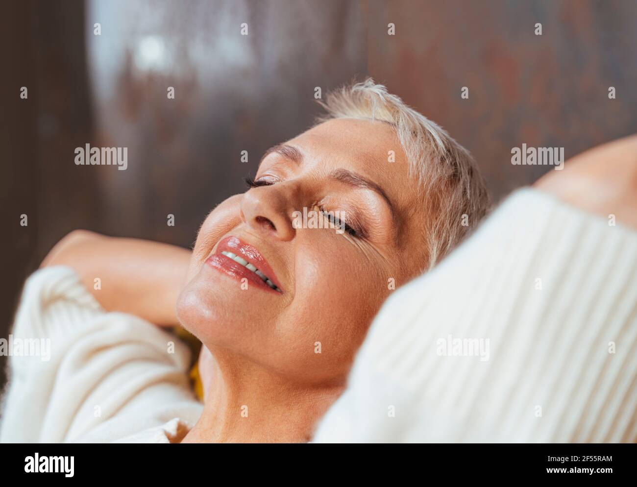 Beautiful senior woman with eyes closed relaxing Stock Photo