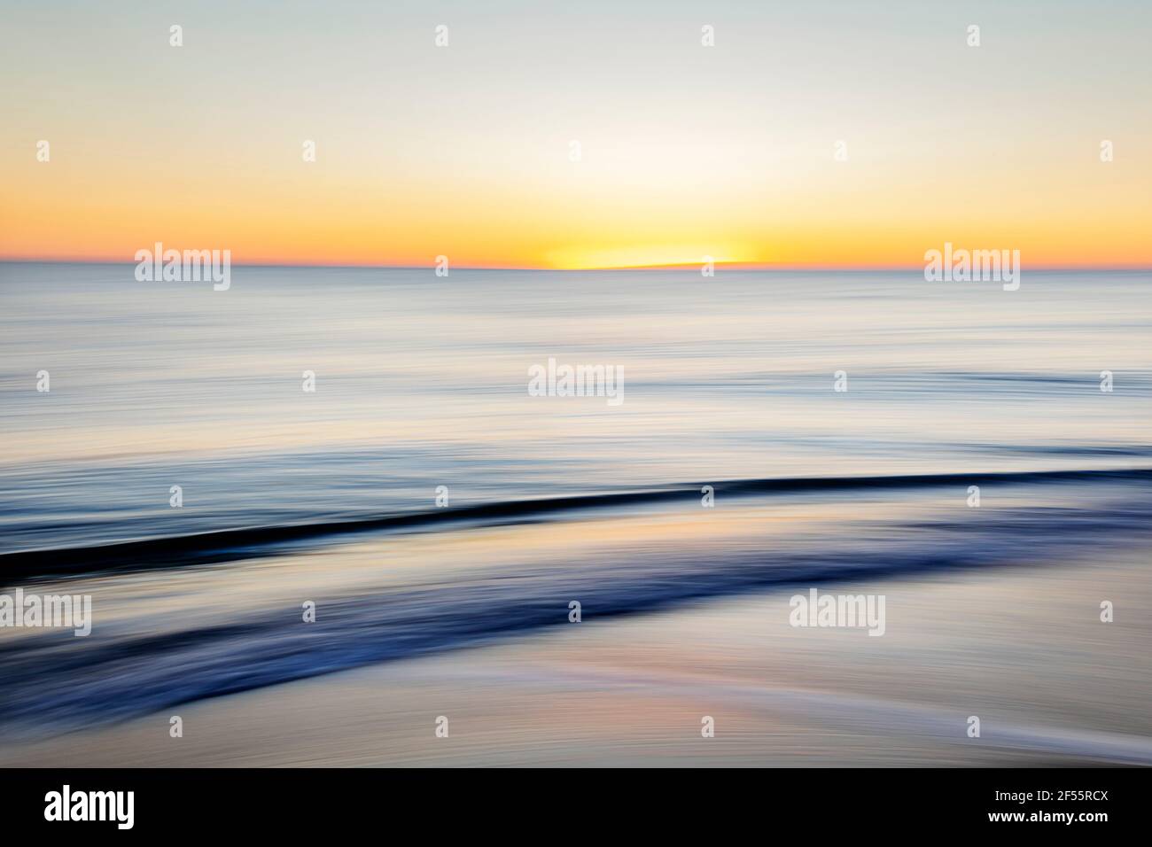 the waves of the sea during the sunset Stock Photo - Alamy