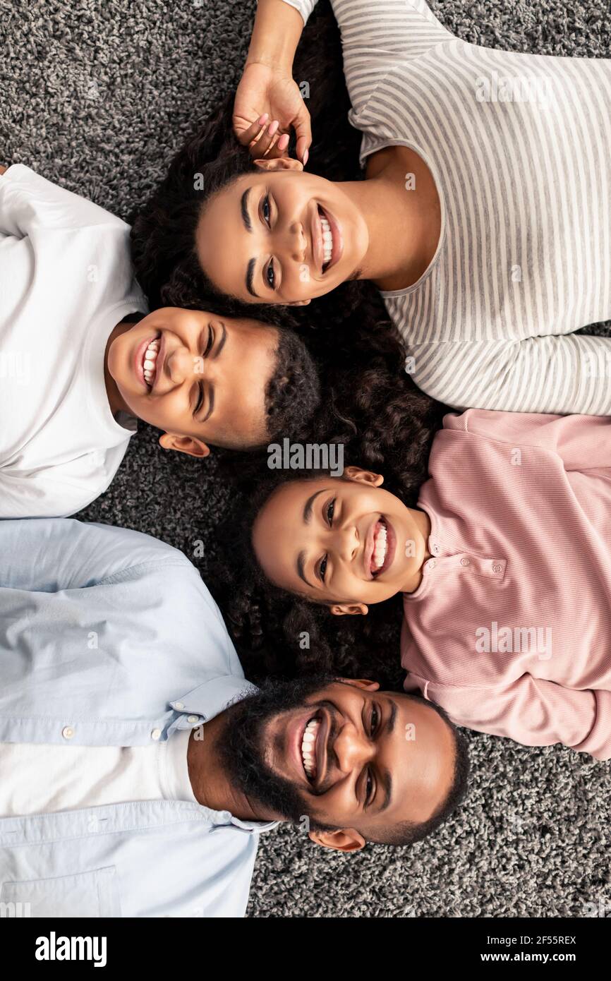 Portrait of black family lying on floor together Stock Photo - Alamy