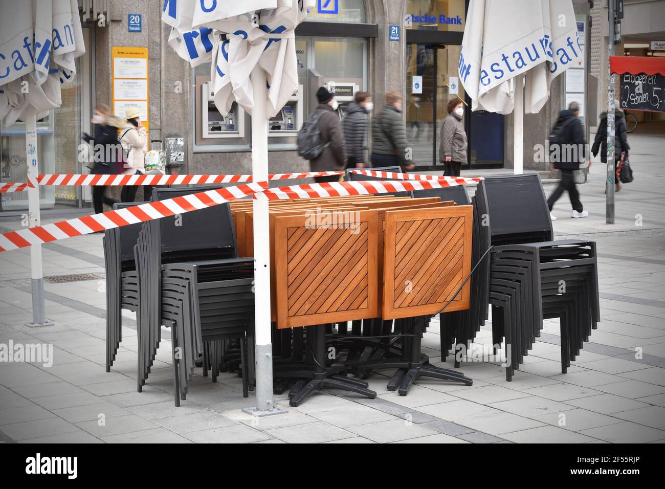 Topic picture: Coronavirus pandemic/consequences for gastronomy: stacked chairs and folded tables in front of a restaurant, cafe, outdoor catering on the Marienplatz on March 23, 2021. | usage worldwide Stock Photo