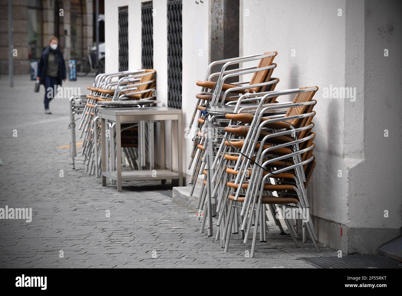 Munich, Deutschland. 23rd Mar, 2021. Topic picture: Coronavirus pandemic/consequences for gastronomy: stacked chairs in front of a restaurant, cafe, outdoor catering on March 23, 2021. | usage worldwide Credit: dpa/Alamy Live News Stock Photo