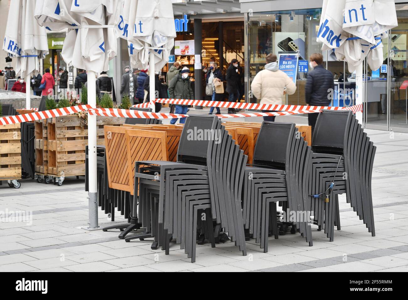 Topic picture: Coronavirus pandemic/consequences for gastronomy: stacked chairs and folded tables in front of a restaurant, cafe, outdoor catering on the Marienplatz on March 23, 2021. | usage worldwide Stock Photo