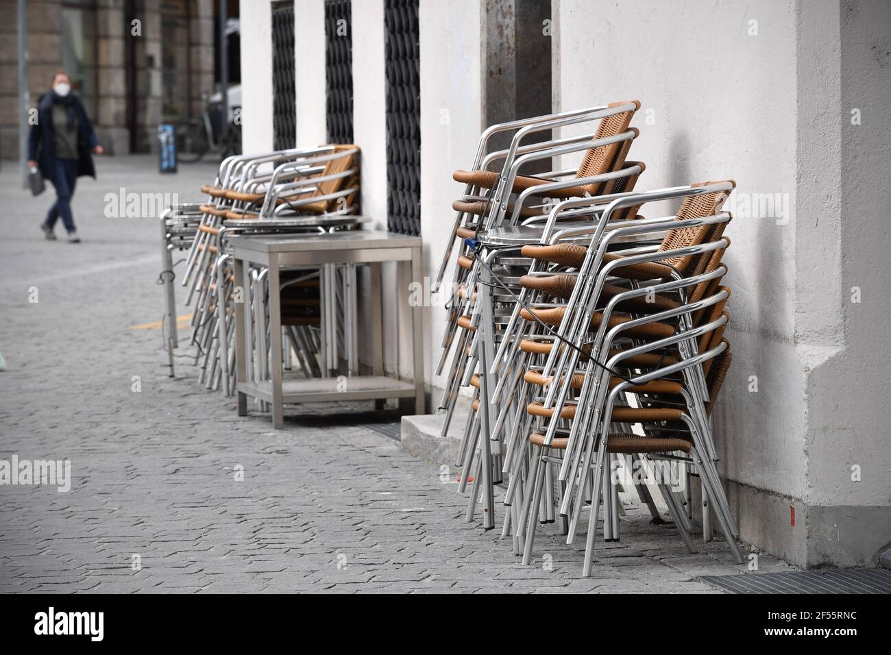 Munich, Deutschland. 23rd Mar, 2021. Topic picture: Coronavirus pandemic/consequences for gastronomy: stacked chairs in front of a restaurant, cafe, outdoor catering on March 23, 2021. | usage worldwide Credit: dpa/Alamy Live News Stock Photo