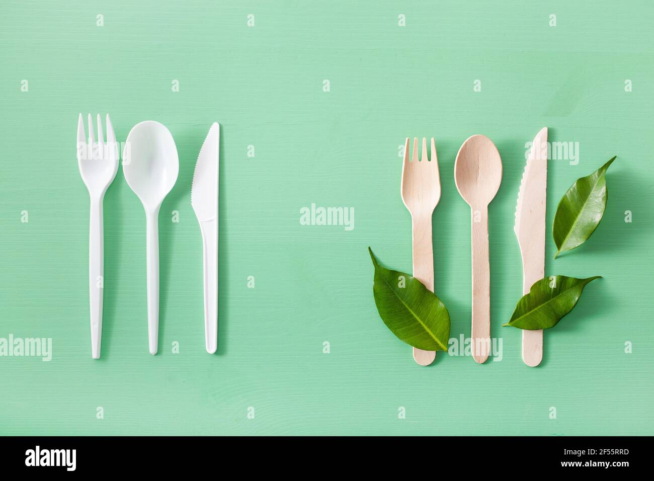 harmful plastic and eco friendly wooden cutlery. plastic free concept