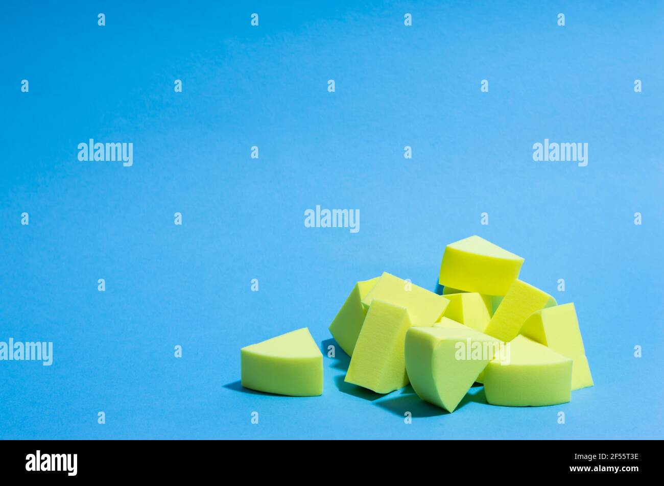 Make-up yellow sponges on a blue background Stock Photo