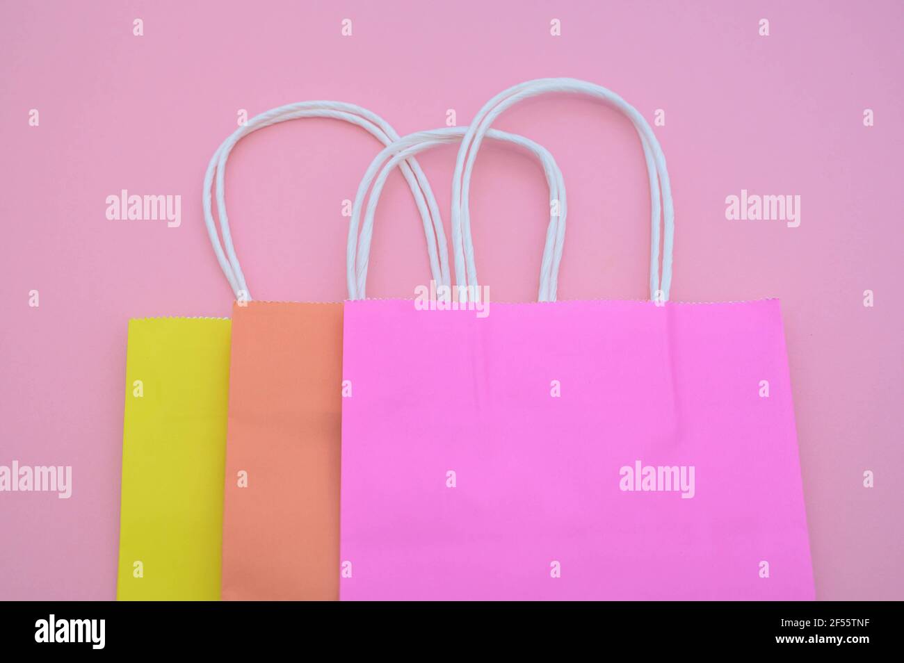 Colorful shopping bags isolated on pastel pink background Stock Photo ...