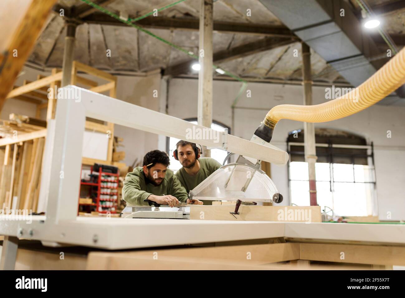 Craftsmen working at table saw in industry Stock Photo
