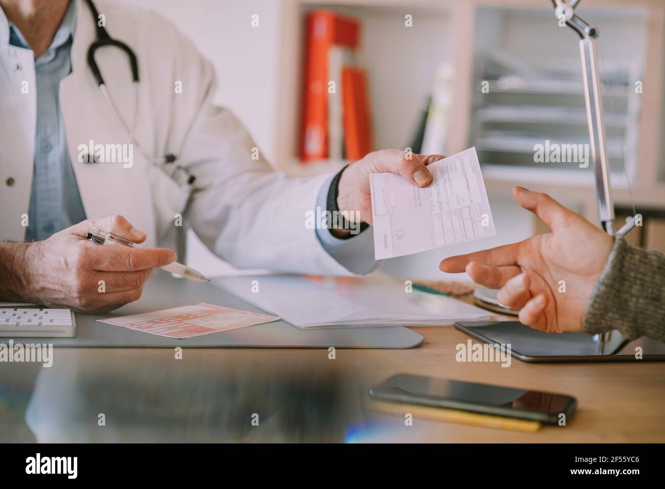 Doctor giving prescription hi-res stock photography and images - Alamy
