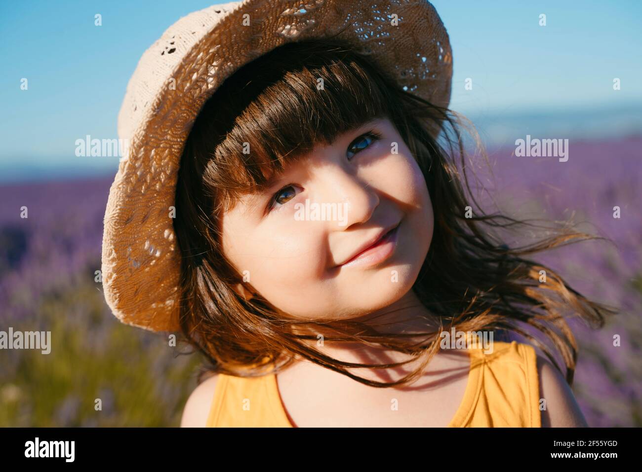 Portrait of cute little girl wearing straw hat standing outdoors Stock ...