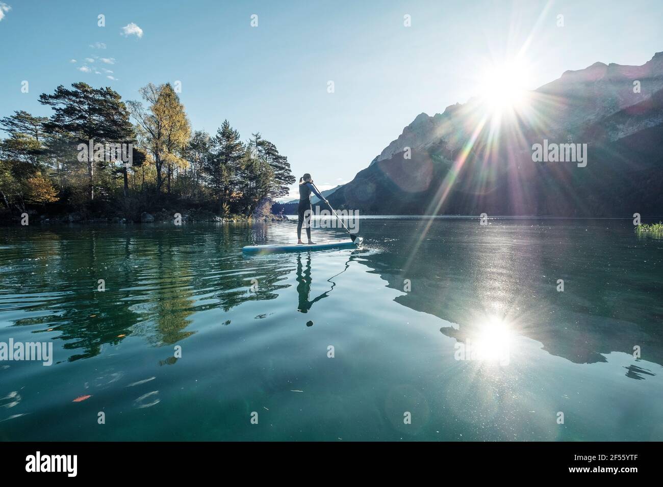 Germany, Bavaria, Garmisch Partenkirchen, Young woman stand up paddling