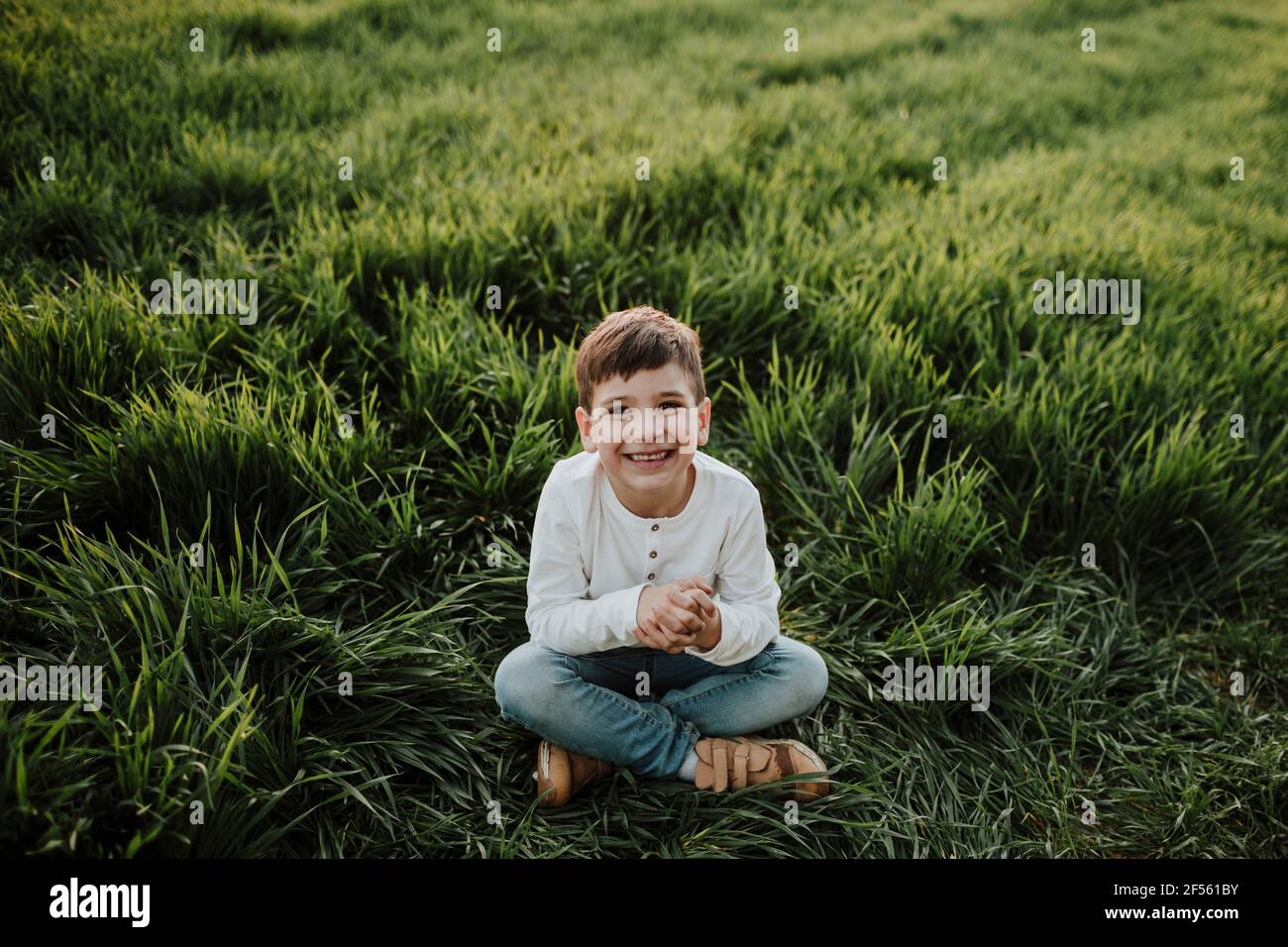 Brother and sister running on meadow against clear sky Stock Photo - Alamy
