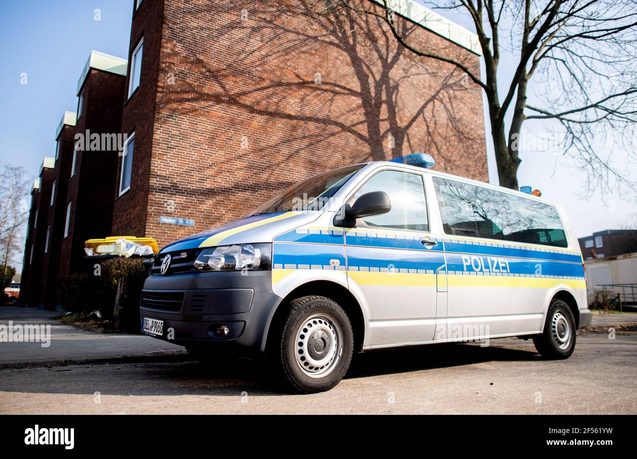 24 March 2021, Lower Saxony, Delmenhorst: A police emergency vehicle is parked in front of an apartment building. A woman has died in a homicide. The 28-year-old victim was fatally injured with a knife, a police spokeswoman said. Photo: Hauke-Christian Dittrich/dpa - ATTENTION: Street sign has been pixelated for legal reasons Stock Photo