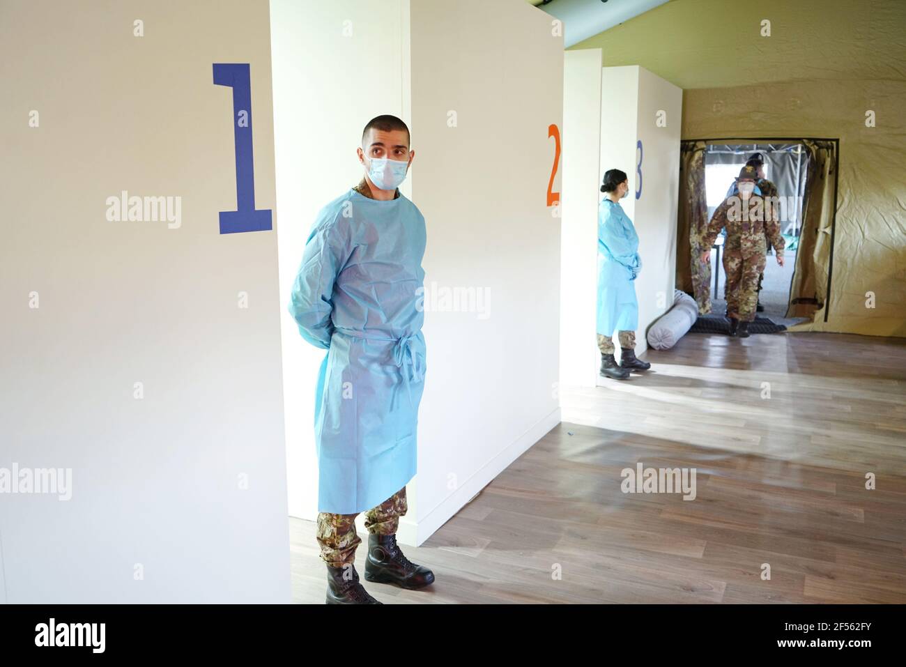 Hotspot for mass immunisation with three vaccination lines manned by army medical staff. Turin, Italy - March 2021 Stock Photo