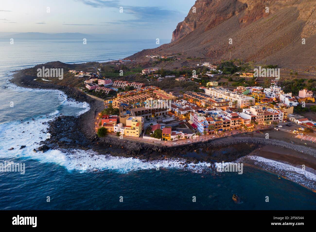 Spain, Valle Gran Rey, Drone view of town at edge of La Gomera island at dusk Stock Photo