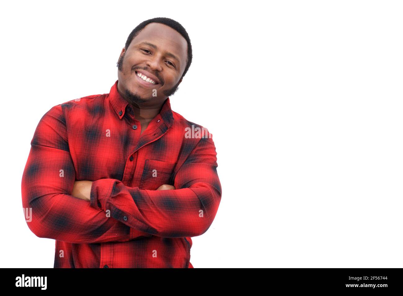 Portrait of a cool young black man smiling with arms crossed on ...