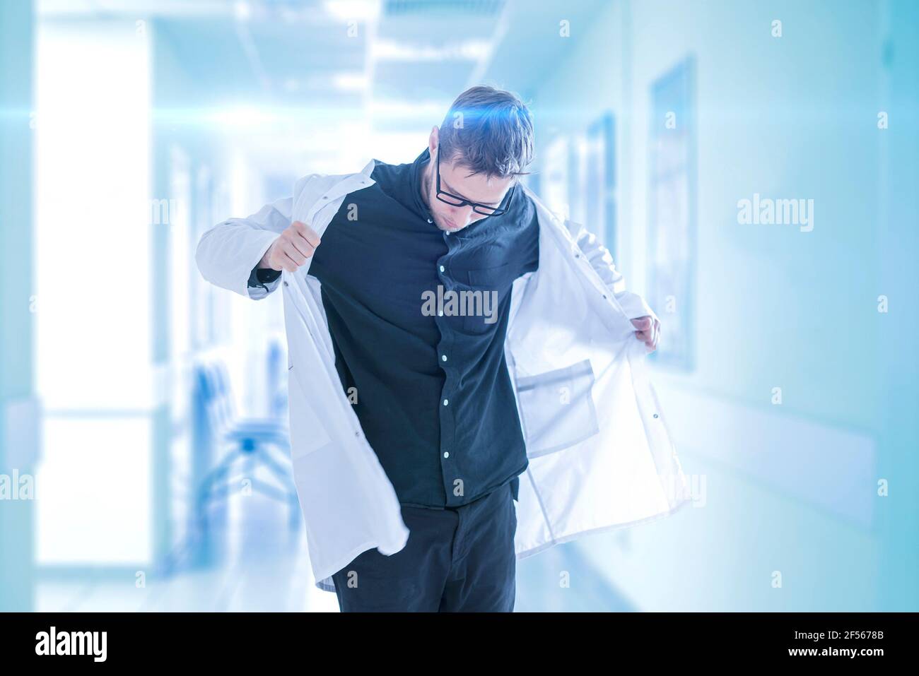 a male doctor put on the medical gown uniform in hospital, clinic young