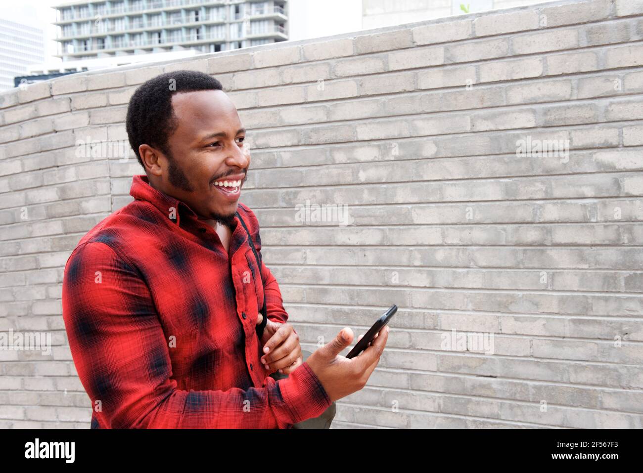 Happy young black man walking hi-res stock photography and images - Alamy