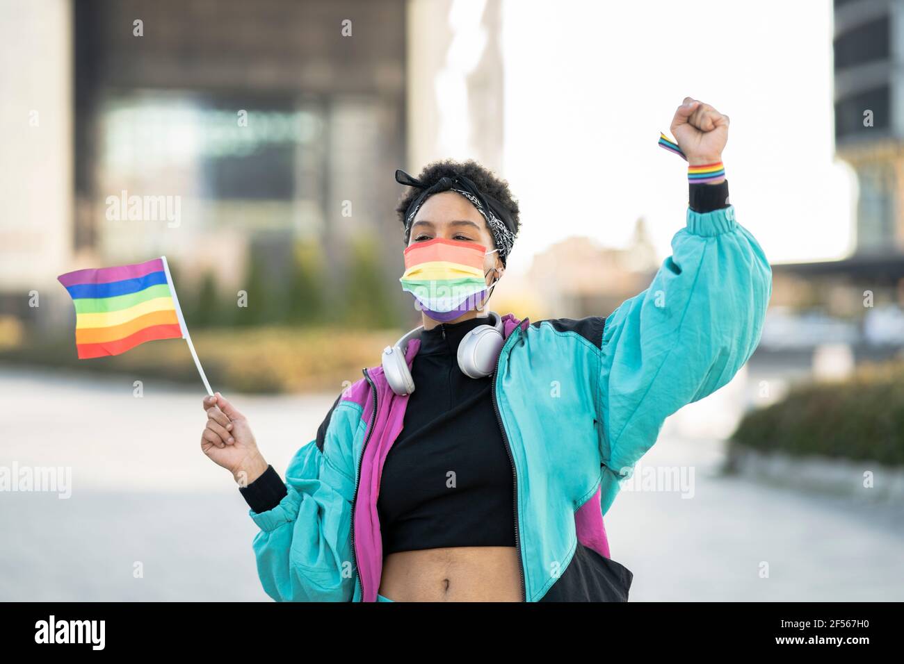 Young woman protesting for LGBTQIA rights in city during COVID-19 Stock Photo